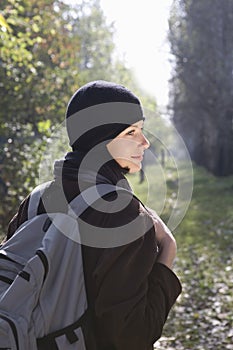 Woman In Winter Clothing With Backpack At Park