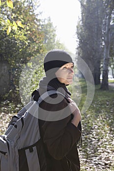 Woman In Winter Clothing With Backpack At Park