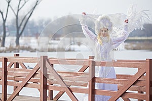 Woman Winter Fashion. Portrait of Sensual Caucasian Blond in Knitted White Dress and Kerchief with Fur Kokoshnik.Posing on Bridge