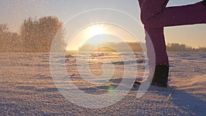 Woman In Winter Field At Sunset Kicked The Snow Feet Throws Snowflakes And Frost