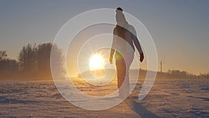 Woman In Winter Field At Sunset Kicked Snow And Glittering Snowflakes And Frost