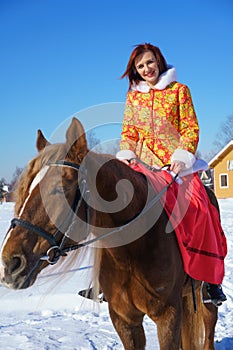 Woman in winter on a horse on a Sunny frosty day