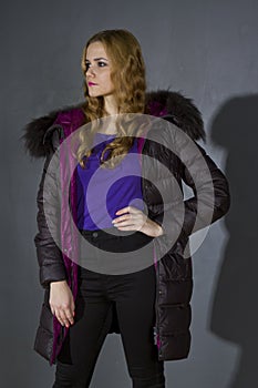 Woman in winter jacket in studio