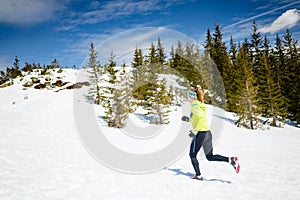 Woman winter running in beautiful inspirational landscape