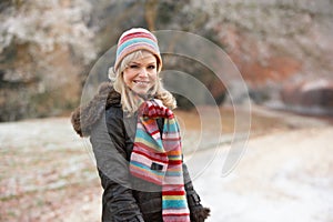 Woman On Winter Walk Through Frosty Landscape