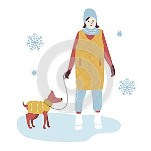 Woman on a Winter Walk in trendy outerwear Walking the Dog. Girl in warm winter Clothes among snowflakes on park