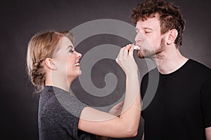 Woman wipe man face by hygienic tissue