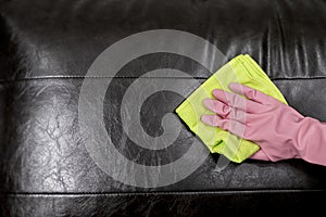 Woman wipe sofa with germicidal spray and wipe with towel