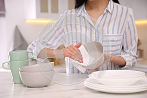 Woman wiping bowl with paper towel in kitchen