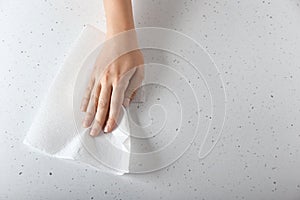 Woman wiping light table with paper towel