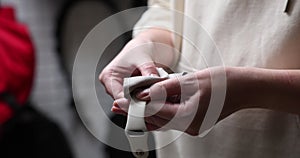 woman wiping smart watch with microfiber close-up of hands