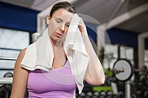 Woman wiping sweat with towel