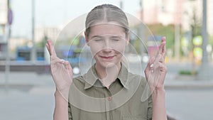 Woman Wishing for Good luck while Standing Outdoor