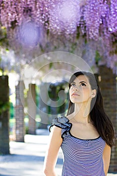 Woman with wisteria flowers. Spring