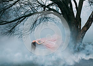 Woman witch floating in air ghost butterfly. luxury long pink silk skirt fabric dress hair waving fly wind. Cold autumn