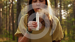 Woman or witch performing magic ritual in forest