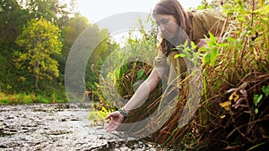 Woman or witch performing magic ritual on river