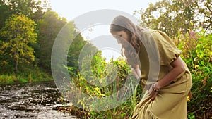 Woman or witch performing magic ritual on river