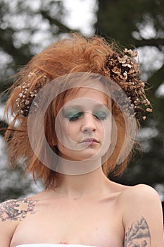 Woman withRed Orange Teased Hair with Dead Flowers