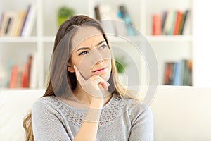 Woman wondering sitting at home photo