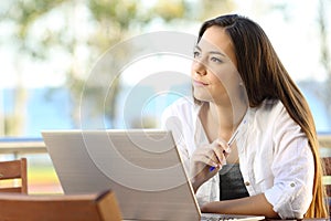 Woman wondering working on a beach apartment photo