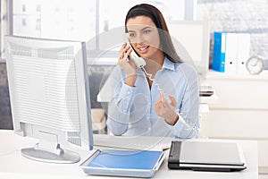 Woman at work on landline call photo