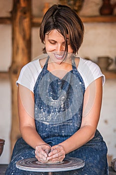 Woman work on potter's wheel