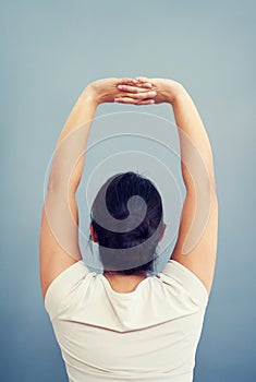 Woman, work and stretching arms on studio, blue background or tired body from working, bad posture or strain. Stretch