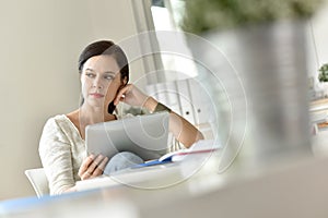 Woman at work using tablet
