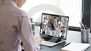 Woman worker engaged in online team briefing on computer