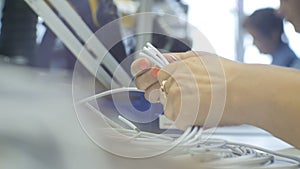 Woman Worker Handly Checks Cable in Production Plant