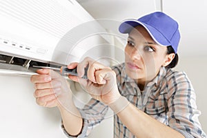 woman worker inspecting air conditioning