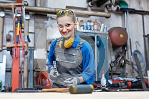 Woman worker marking workpiece in her workshop