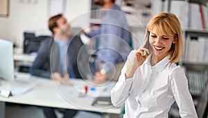Woman worker at office.business woman enjoying  at workand talking on a mobile phone
