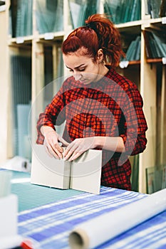 Woman worker packing products for shipment