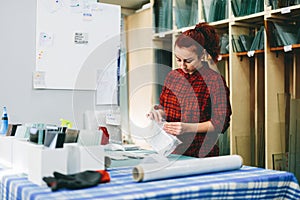 Woman worker packing products for shipment