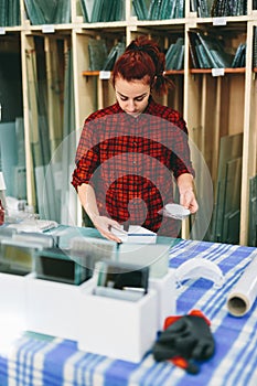 Woman worker packing products for shipment