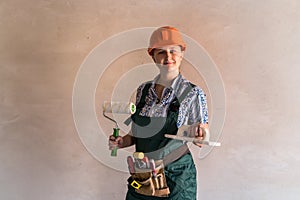 Woman worker in protective uniform with painting tools
