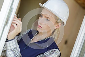 woman worker screwing window