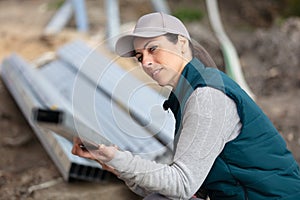 woman worker settling metal net material