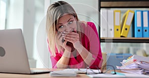 Woman worker shares gossip on mobile phone at desk in office