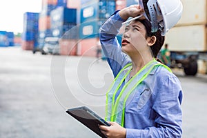 Woman worker tired fatigue from hardwork overload and outdoor hot weather sweating in port cargo shipping industry