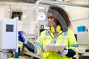 woman worker work control operate CNC wood milling machine in wood furniture workshop. technician staff women working with modern