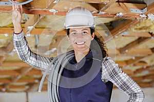 woman worker working on replacing roof drain pipes