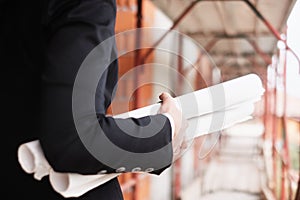 Woman Working As Engineer Holding Building Plans