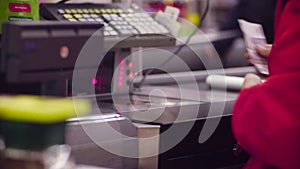 Woman working on cash register in the store