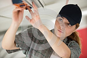 Woman working on ceiling