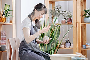 Woman working with clay next to a pottery wheel for future ceramics