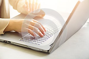 Woman working on computer close up. Woman hands typing on keyboard of laptop, online shopping detail. Business, remote photo