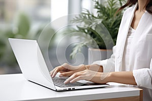 Woman working on computer in modern office, close up. Woman hands typing on keyboard of laptop, online shopping detail